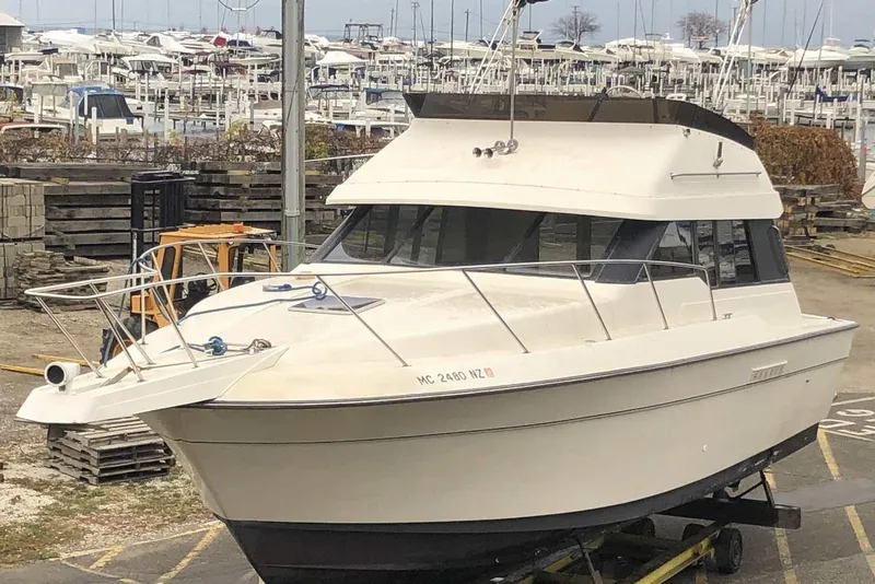 Slide: The Image of 1990 Silverton 34 Convertible boat docked at a marina with numerous boats in the background. - 26