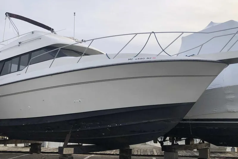 Slide: The Image of 1990 Silverton 34 Convertible yacht on dry dock, side view. - 27
