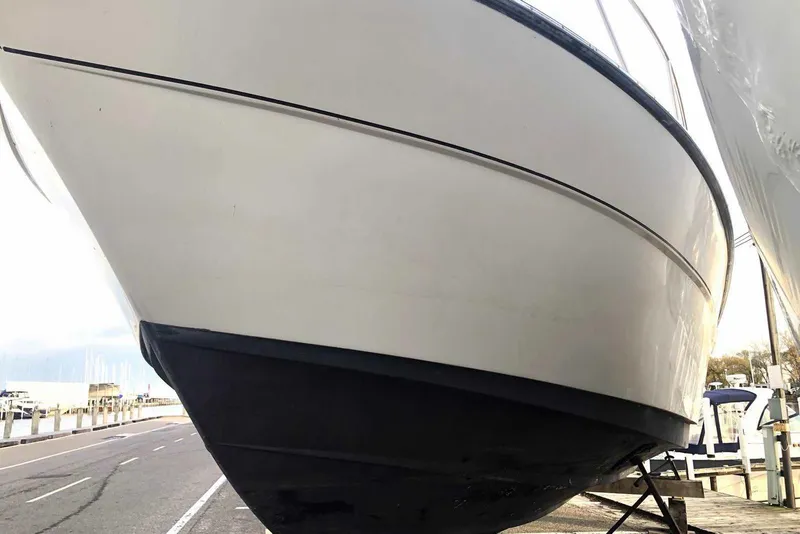 Slide: The Image of 1990 Silverton 34 Convertible boat on dry dock, side view. - 29