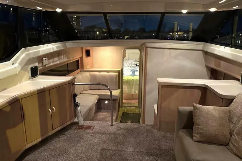 Slide: The Image of Interior of 1990 Silverton 34 Convertible yacht, featuring cozy seating and modern design. - 3