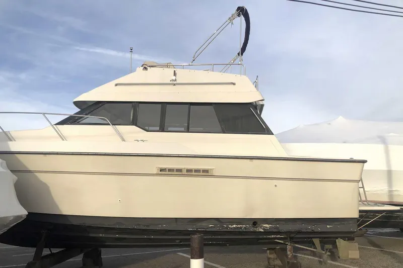 Slide: The Image of 1990 Silverton 34 Convertible boat on dry dock under a clear sky. - 30