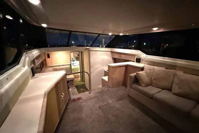 Slide: The Image of Luxurious interior of a 1990 Silverton 34 Convertible yacht with cozy seating and ambient lighting. - 4