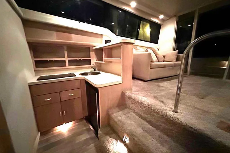 Slide: The Image of Interior of 1990 Silverton 34 Convertible yacht with kitchenette and cozy seating area. - 6