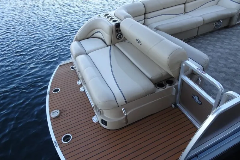 Slide: The Image of 2010 Harris Grand Mariner 230 pontoon boat with beige seating and wooden deck. - 10