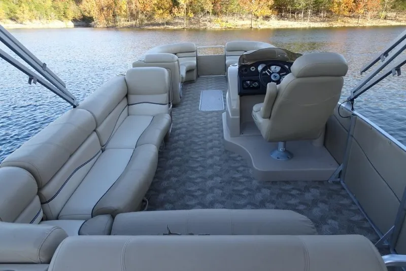 Slide: The Image of 2010 Harris Grand Mariner 230 pontoon boat with beige seating on a calm lake. - 12