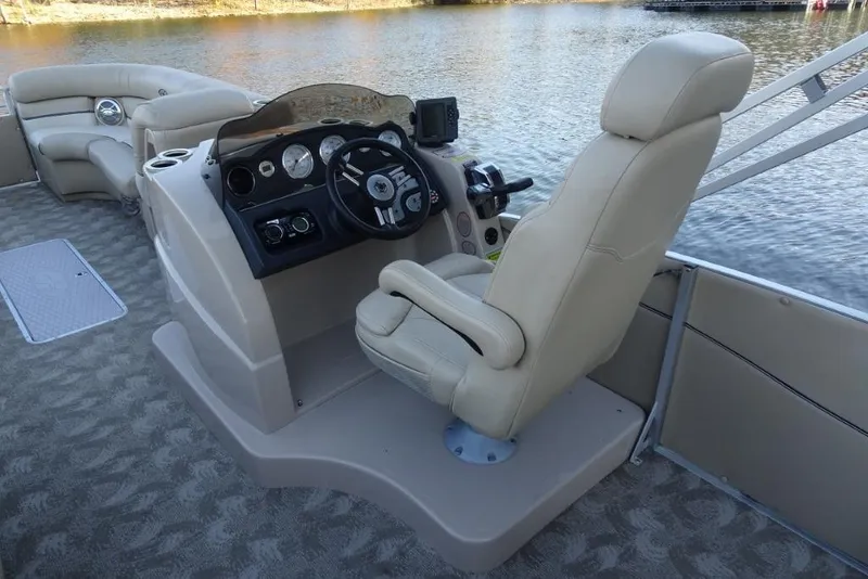 Slide: The Image of 2010 Harris Grand Mariner 230 boat interior with steering console and beige seating. - 13