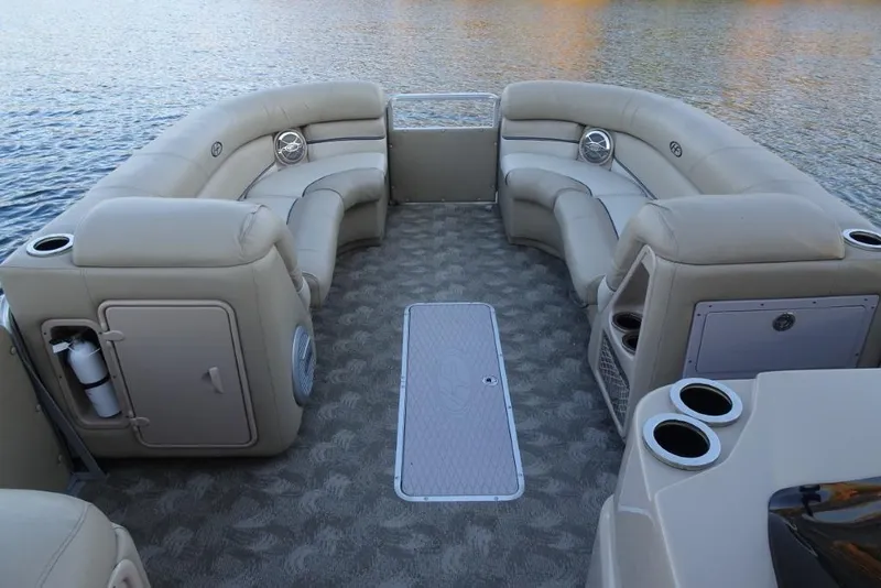 Slide: The Image of 2010 Harris Grand Mariner 230 pontoon boat interior with beige seating and cup holders. - 17
