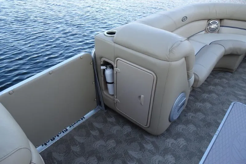 Slide: The Image of 2010 Harris Grand Mariner 230 pontoon boat interior with beige seating and water view. - 18