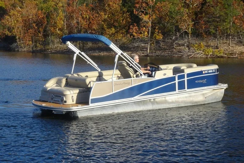 Slide: The Image of 2010 Harris Grand Mariner 230 pontoon boat cruising on a lake with autumn foliage. - 2