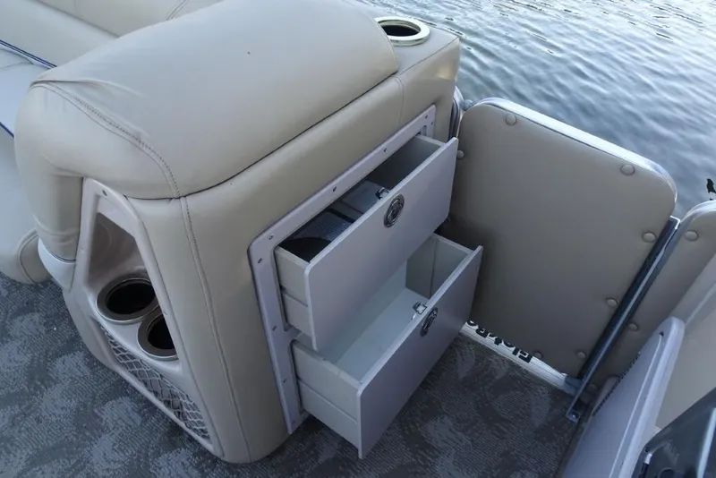 Slide: The Image of 2010 Harris Grand Mariner 230 boat interior with storage drawers and cup holders. - 20