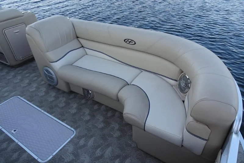 Slide: The Image of 2010 Harris Grand Mariner 230 boat interior with beige seating and water view. - 22