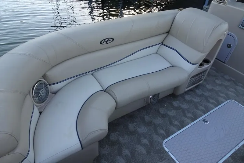 Slide: The Image of Luxurious seating on a 2010 Harris Grand Mariner 230 pontoon boat, featuring beige upholstery. - 23