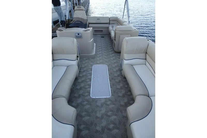 Slide: The Image of 2010 Harris Grand Mariner 230 pontoon boat with beige seating and spacious deck layout. - 24