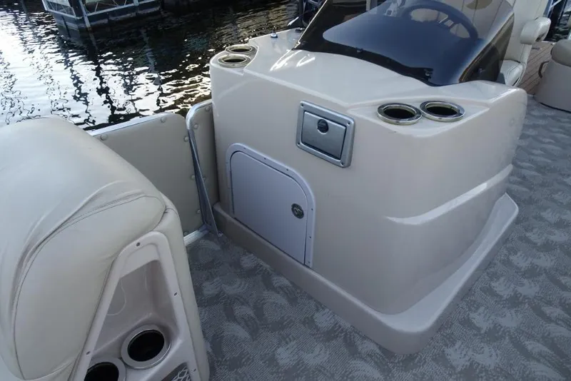 Slide: The Image of 2010 Harris Grand Mariner 230 boat interior with helm and cup holders. - 25