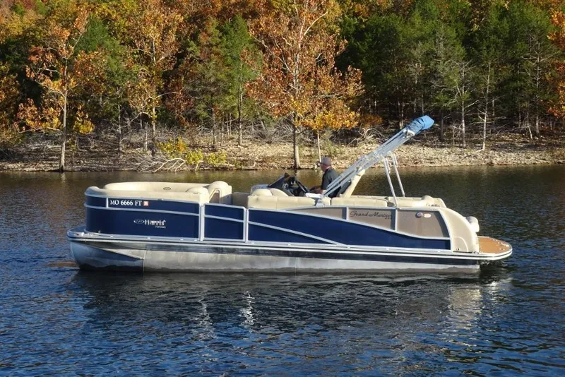 Slide: The Image of 2010 Harris Grand Mariner 230 pontoon boat on a lake with autumn trees in the background. - 5