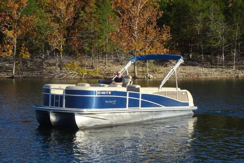Slide: The Image of 2010 Harris Grand Mariner 230 pontoon boat cruising on a lake with autumn trees in the background. - 7