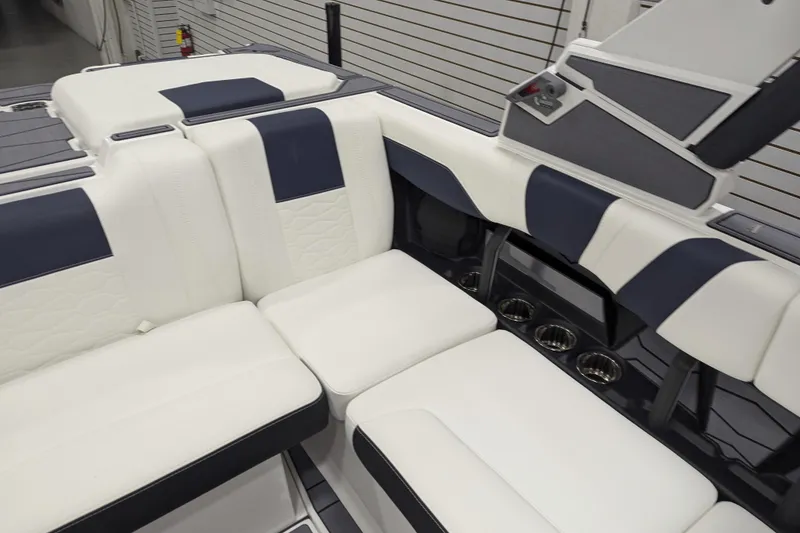 Slide: The Image of 2026 Malibu Wakesetter 22 MXZ interior with white and navy seating, cup holders, and sleek design. - 10