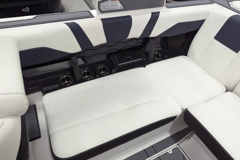 Slide: The Image of 2026 Malibu Wakesetter 22 MXZ interior with white cushioned seating and cup holders. - 12