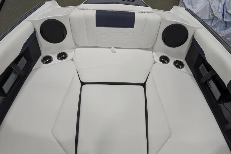Slide: The Image of 2026 Malibu Wakesetter 22 MXZ interior with white seating and cup holders. - 15