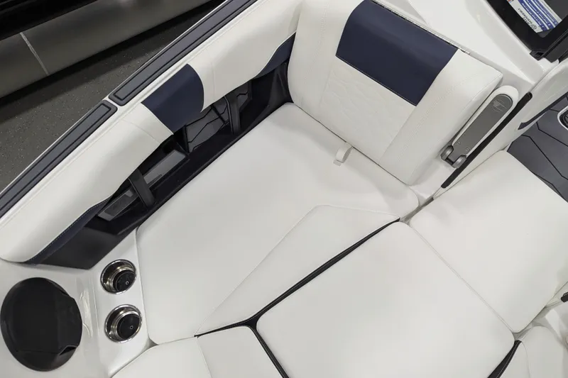 Slide: The Image of 2026 Malibu Wakesetter 22 MXZ interior with white and navy seating, cup holders, and sleek design. - 18