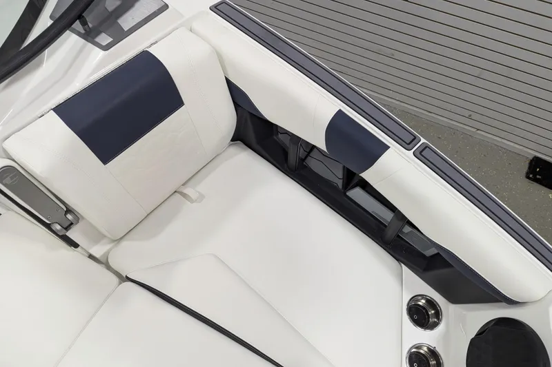 Slide: The Image of 2026 Malibu Wakesetter 22 MXZ interior with white and navy seating, cup holders. - 19