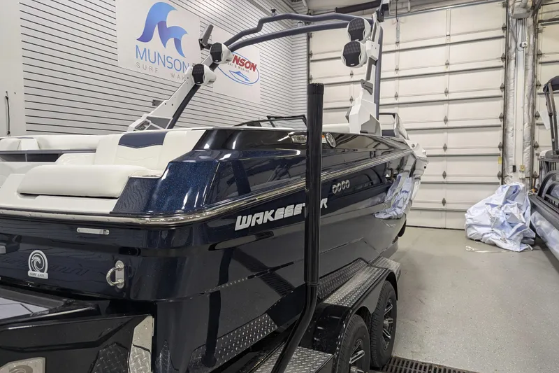 Slide: The Image of 2026 Malibu Wakesetter 22 MXZ boat in showroom, featuring sleek design and modern features. - 2