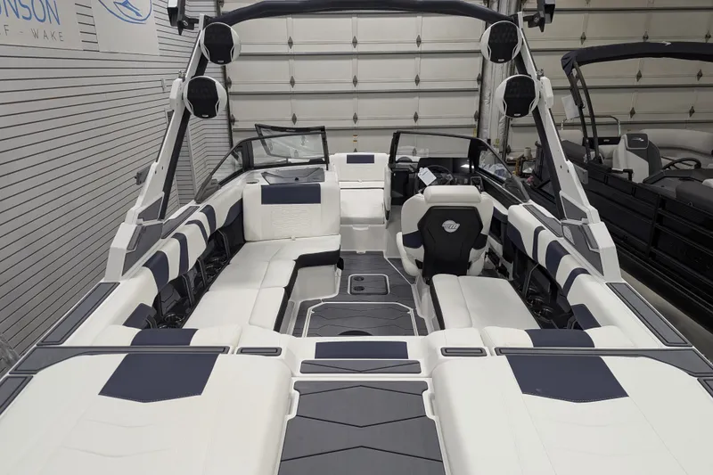 Slide: The Image of 2026 Malibu Wakesetter 22 MXZ interior, featuring sleek seating and modern design in a showroom. - 20