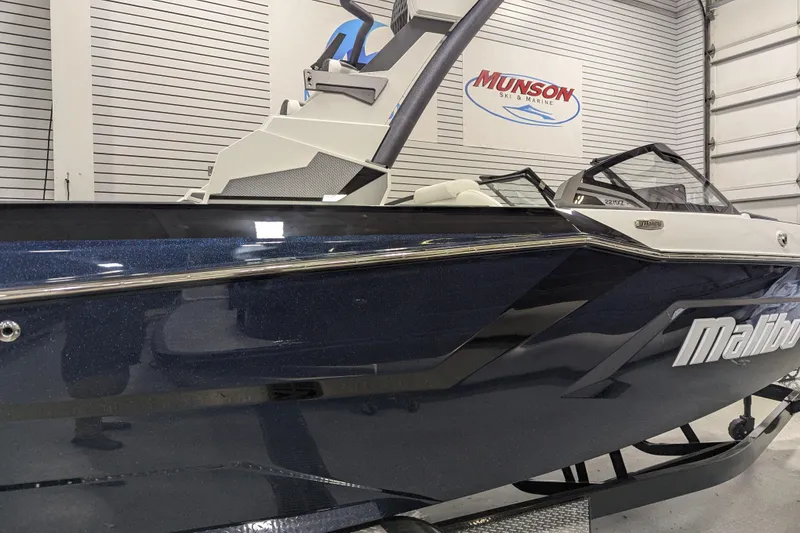 Slide: The Image of 2026 Malibu Wakesetter 22 MXZ boat in showroom, featuring sleek design and modern detailing. - 3