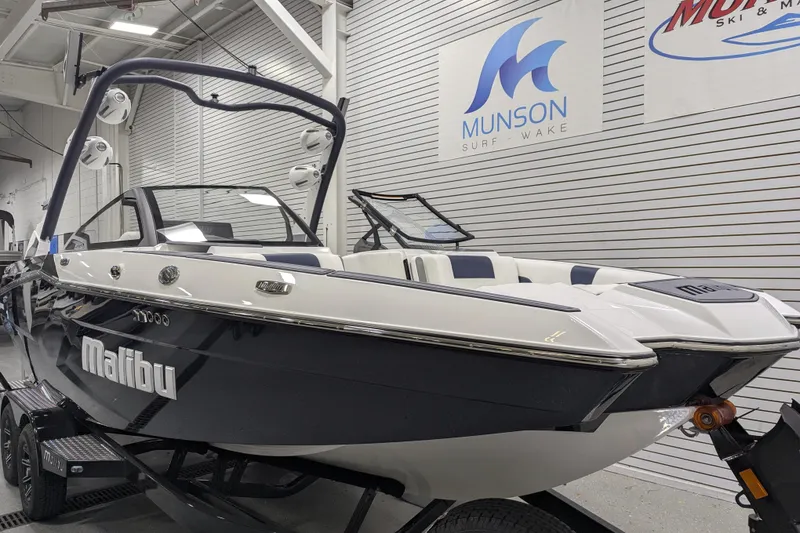 Slide: The Image of 2026 Malibu Wakesetter 22 MXZ boat in showroom, featuring sleek design and modern features. - 4