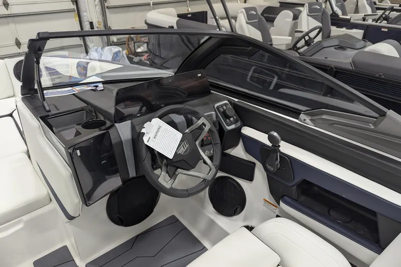 Slide: The Image of 2026 Malibu Wakesetter 22 MXZ boat interior with modern dashboard and steering wheel. - 6