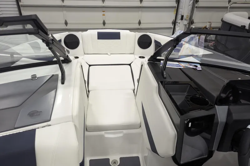 Slide: The Image of 2026 Malibu Wakesetter 22 MXZ interior with white seating and modern dashboard design. - 7