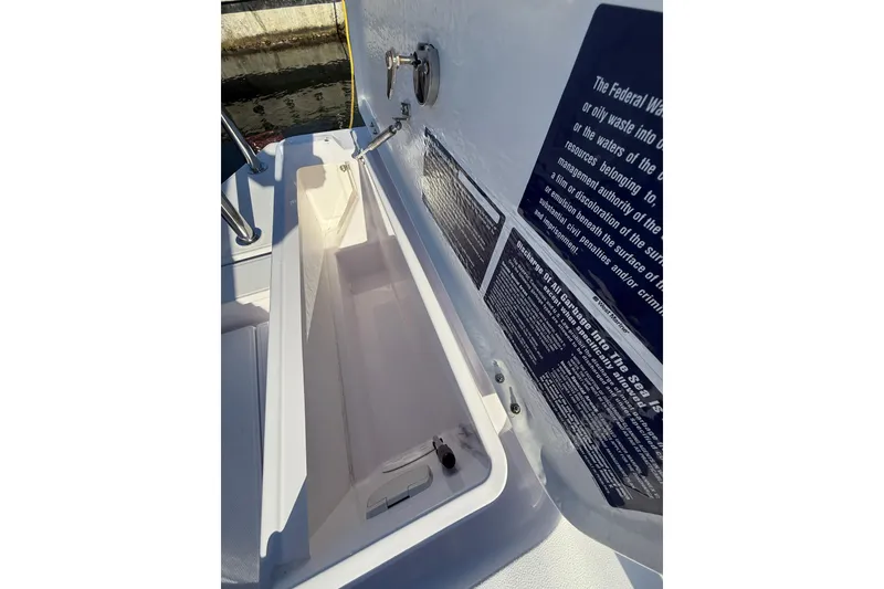 Slide: The Image of Open storage compartment on 2023 Axopar 28 Cabin Wet Bar boat. - 10