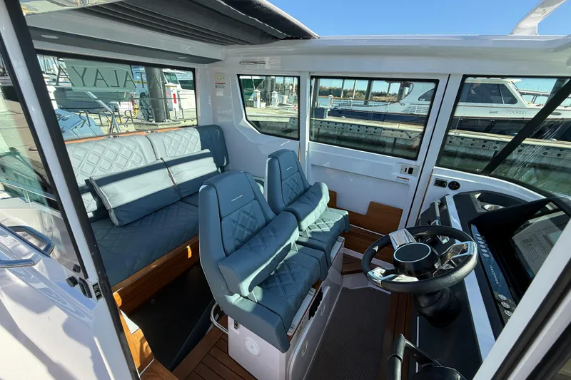 Slide: The Image of 2023 Axopar 28 Cabin Wet Bar with sleek seating and modern design. - 13