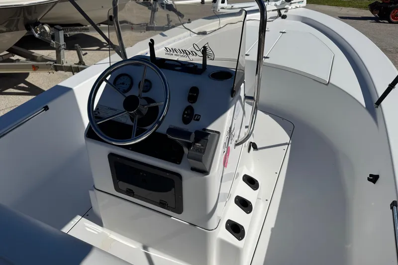 Slide: The Image of 2016 Sportsman Island Bay 20 boat interior with steering console and gauges. - 16