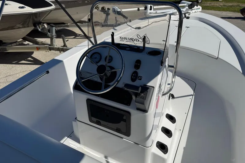 Slide: The Image of 2016 Sportsman Island Bay 20 boat console with steering wheel and controls. - 17