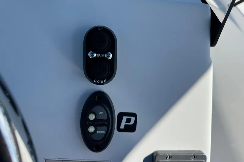 Slide: The Image of Control panel on 2016 Sportsman Island Bay 20 boat, featuring trim and directional buttons. - 19