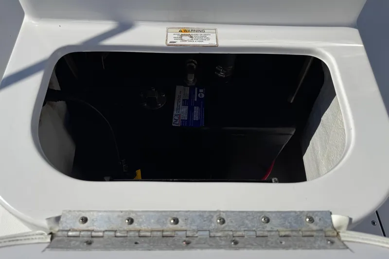 Slide: The Image of Open hatch of 2016 Sportsman Island Bay 20 boat showing battery compartment. - 23