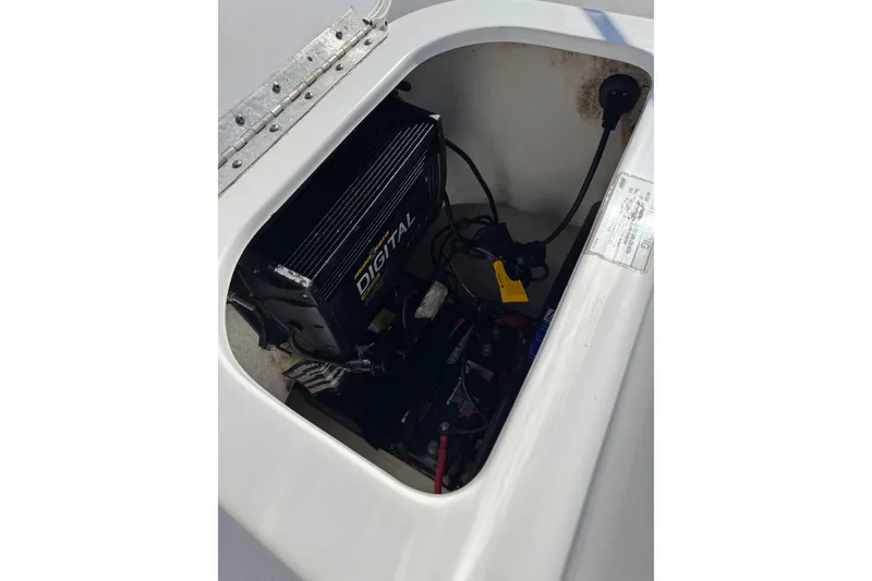 Slide: The Image of Battery compartment of 2016 Sportsman Island Bay 20 boat with digital charger. - 25