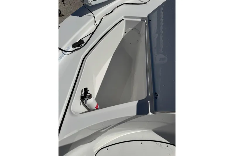Slide: The Image of 2016 Sportsman Island Bay 20 boat storage compartment with fire extinguisher. - 28