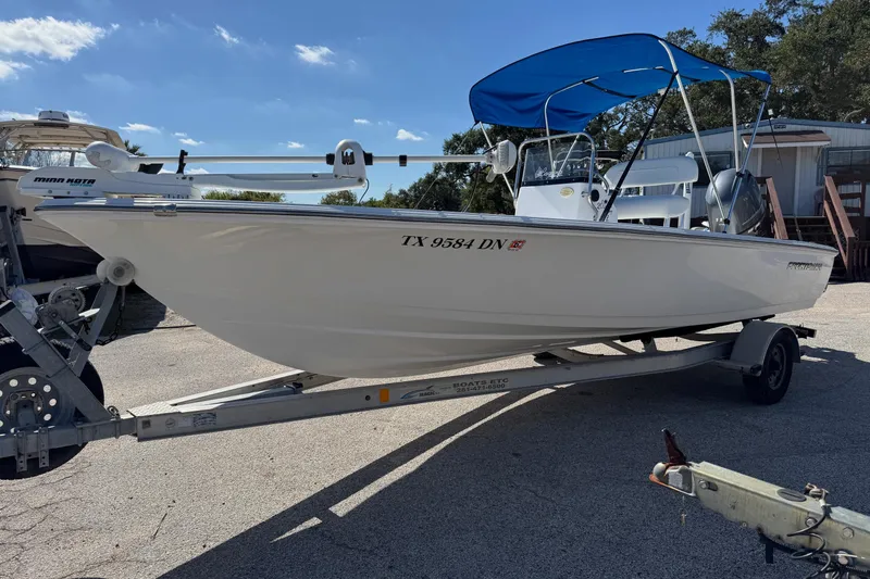 Slide: The Image of 2016 Sportsman Island Bay 20 boat on trailer with blue canopy, parked outdoors. - 30