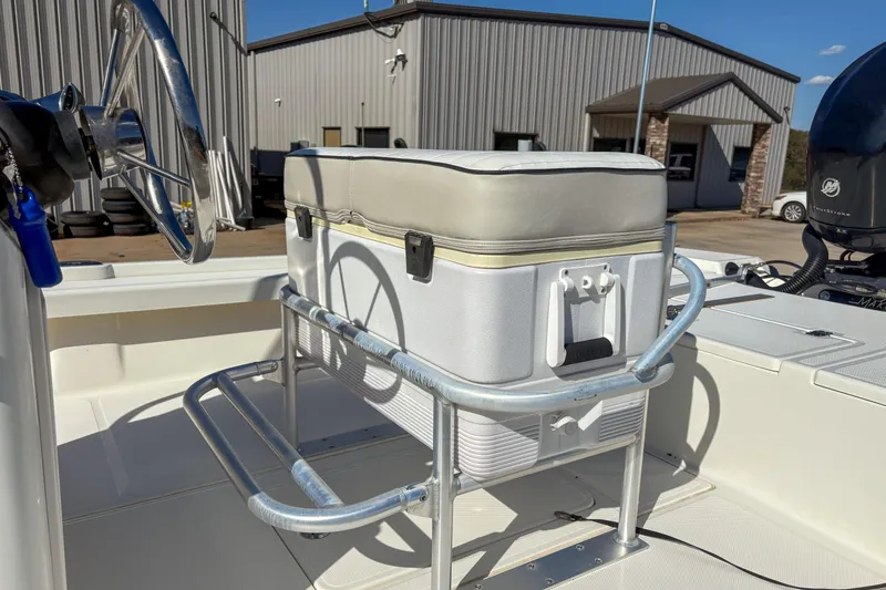 Slide: The Image of 2017 Mako 21 LTS boat interior with steering wheel and cooler seat. - 5