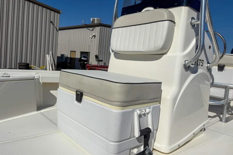 Slide: The Image of 2017 Mako 21 LTS boat interior with cushioned seating and storage compartment. - 8