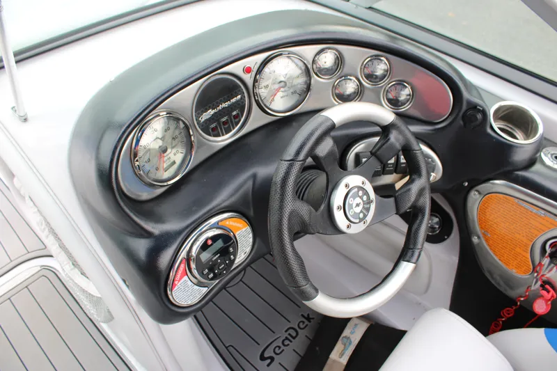 Slide: The Image of Dashboard of 2010 Correct Craft AIR NAUTIQUE SV 211 with steering wheel and gauges. - 10