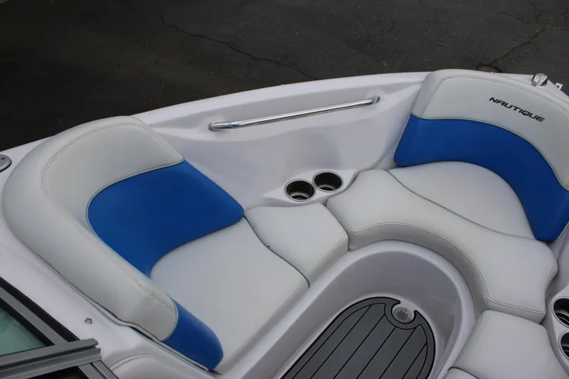 Slide: The Image of 2010 Correct Craft AIR NAUTIQUE SV 211 boat interior with blue and white seating. - 13