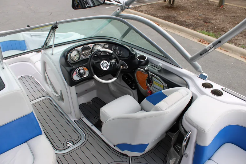 Slide: The Image of 2010 Correct Craft AIR NAUTIQUE SV 211 boat interior with steering wheel and dashboard. - 16