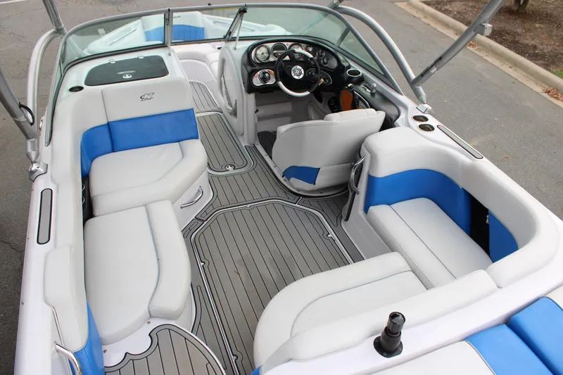 Slide: The Image of 2010 Correct Craft AIR NAUTIQUE SV 211 interior with blue and white seating. - 17