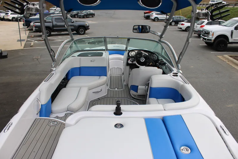 Slide: The Image of 2010 Correct Craft AIR NAUTIQUE SV 211 boat interior with blue and white seating. - 18