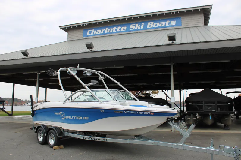 Slide: The Image of 2010 Correct Craft AIR NAUTIQUE SV 211 boat at Charlotte Ski Boats dealership. - 2