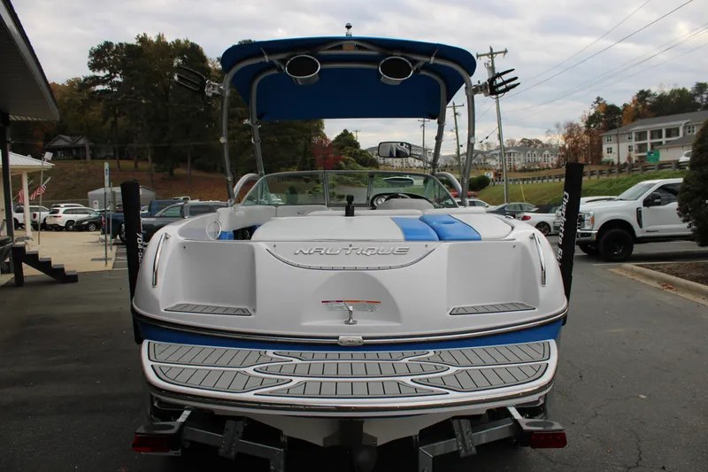 Slide: The Image of 2010 Correct Craft AIR NAUTIQUE SV 211 boat, rear view, parked outdoors. - 20