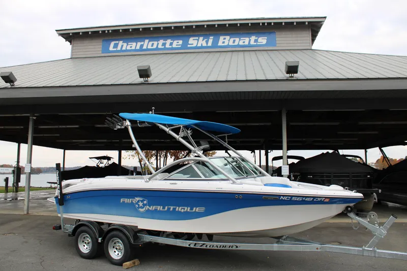 Slide: The Image of 2010 Correct Craft AIR NAUTIQUE SV 211 boat on trailer at Charlotte Ski Boats. - 21
